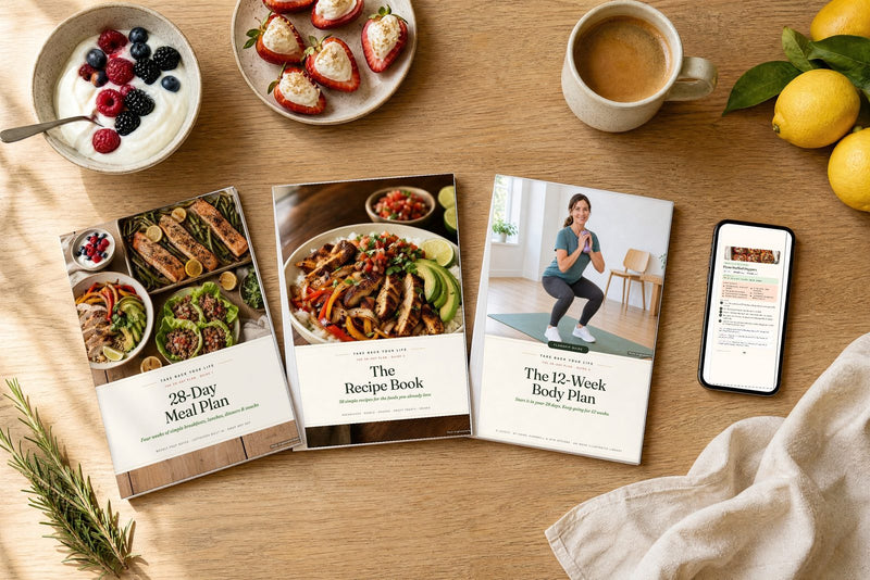 The 28-Day Plan guides on a kitchen table